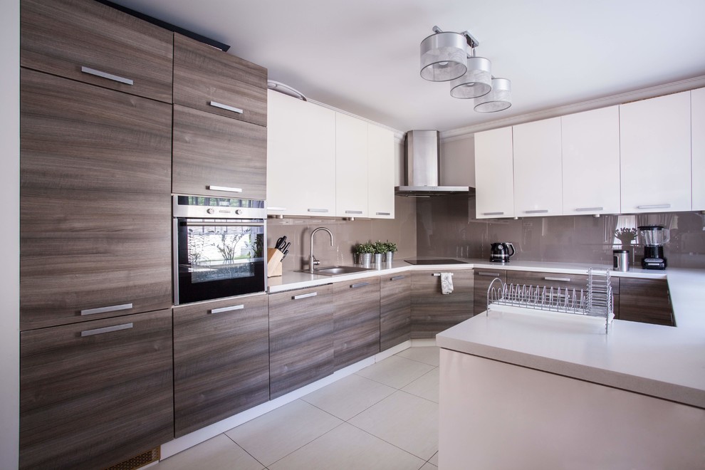 This is an example of a medium sized modern single-wall kitchen/diner in Las Vegas with flat-panel cabinets, white cabinets, laminate countertops, white splashback, plywood flooring, an island, beige floors and white worktops.