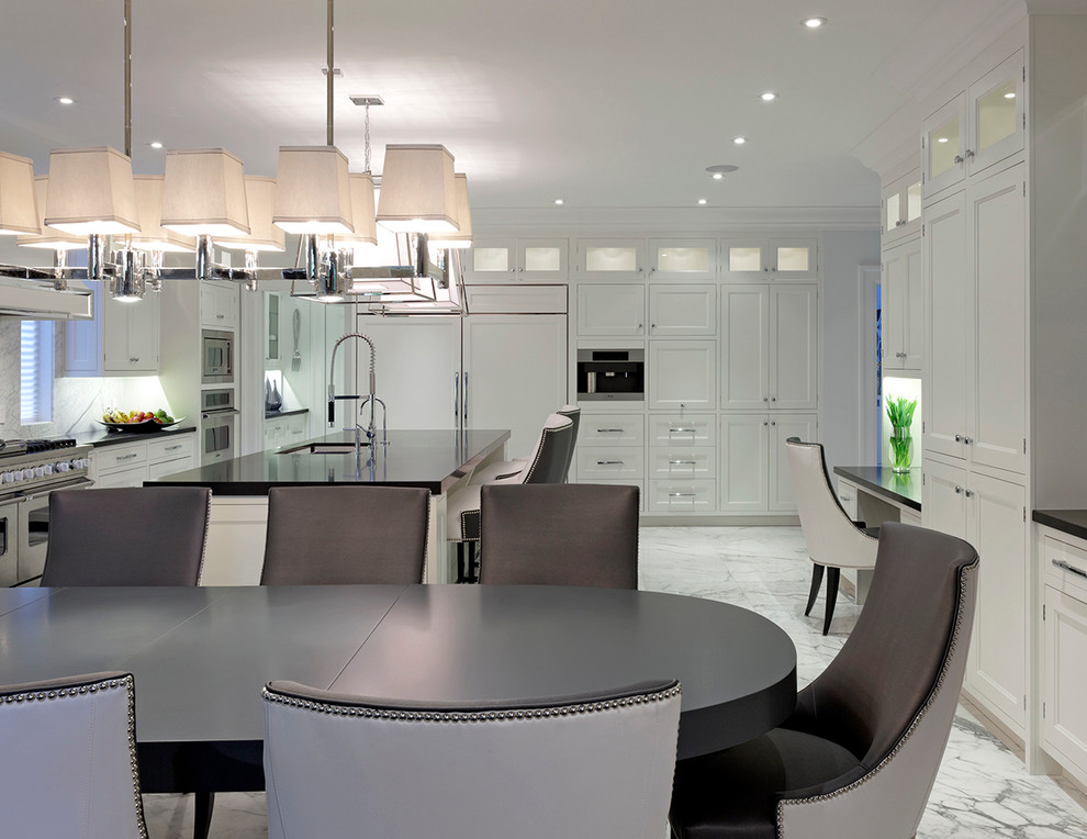 Photo of a large contemporary l-shaped kitchen/diner in Toronto with a submerged sink, recessed-panel cabinets, white cabinets, engineered stone countertops, grey splashback, integrated appliances, marble flooring and an island.