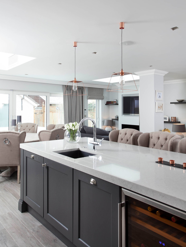 Inspiration for a large classic l-shaped open plan kitchen in Other with a submerged sink, shaker cabinets, grey cabinets, quartz worktops, grey splashback, stone slab splashback, stainless steel appliances, porcelain flooring, an island and brown floors.