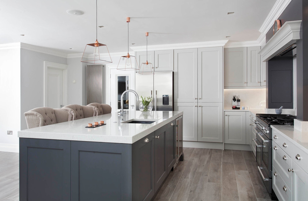Design ideas for a large traditional l-shaped open plan kitchen in Other with a submerged sink, shaker cabinets, grey cabinets, quartz worktops, grey splashback, stone slab splashback, stainless steel appliances, porcelain flooring, an island and brown floors.