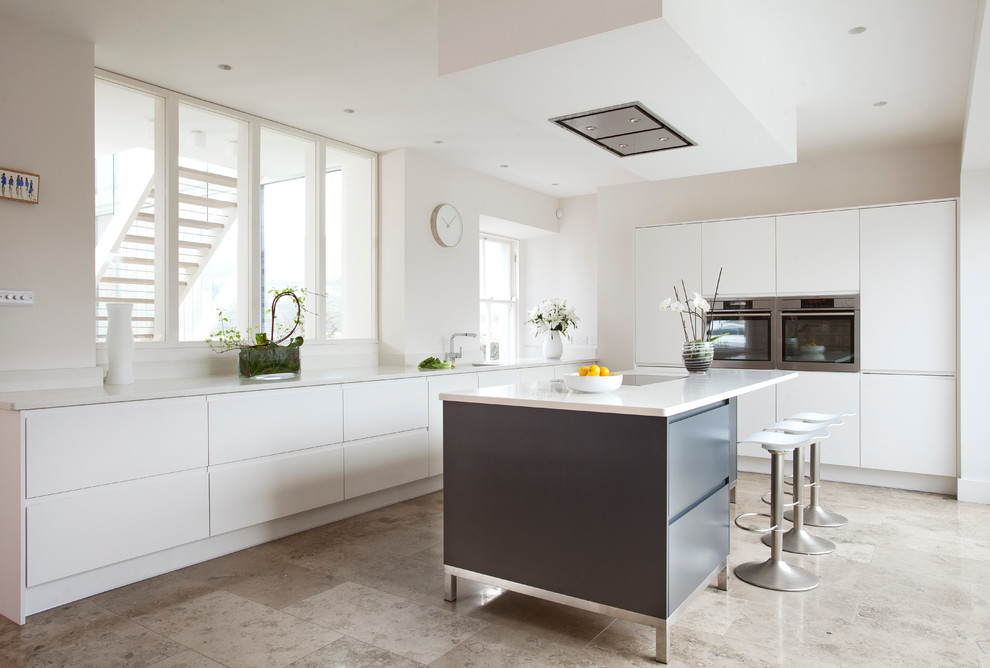 Foto de cocina contemporánea con puertas de armario blancas, encimera de cuarcita, electrodomésticos de acero inoxidable y suelo de mármol