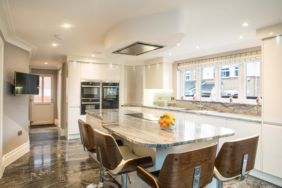 Trendy limestone floor kitchen photo in Hampshire with granite countertops