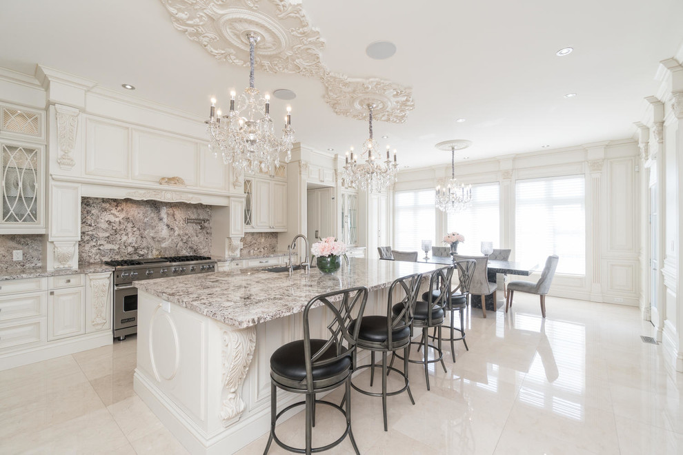 Eat-in kitchen - large transitional l-shaped marble floor and blue floor eat-in kitchen idea in Toronto with a double-bowl sink, raised-panel cabinets, beige cabinets, granite countertops, multicolored backsplash, marble backsplash, stainless steel appliances and an island