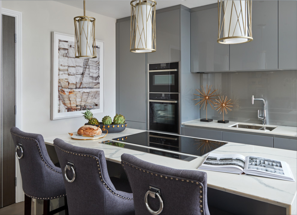 Inspiration for a small contemporary kitchen in Other with a double-bowl sink, flat-panel cabinets, grey cabinets, grey splashback, integrated appliances, an island and white worktops.