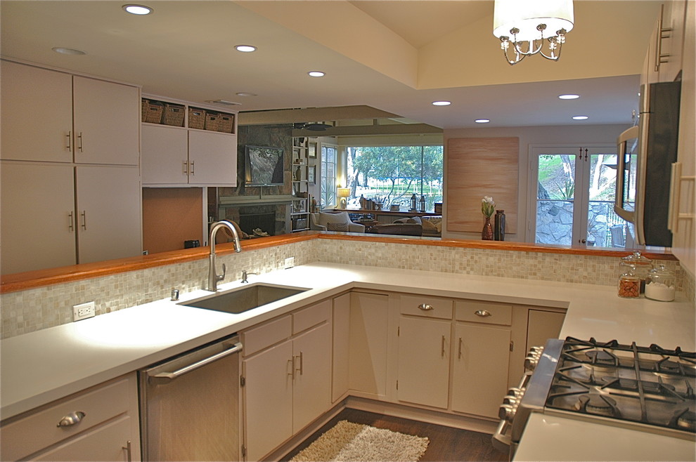 Eat-in kitchen - transitional u-shaped eat-in kitchen idea in Los Angeles with an undermount sink, flat-panel cabinets, gray cabinets, quartz countertops, multicolored backsplash, glass tile backsplash and stainless steel appliances