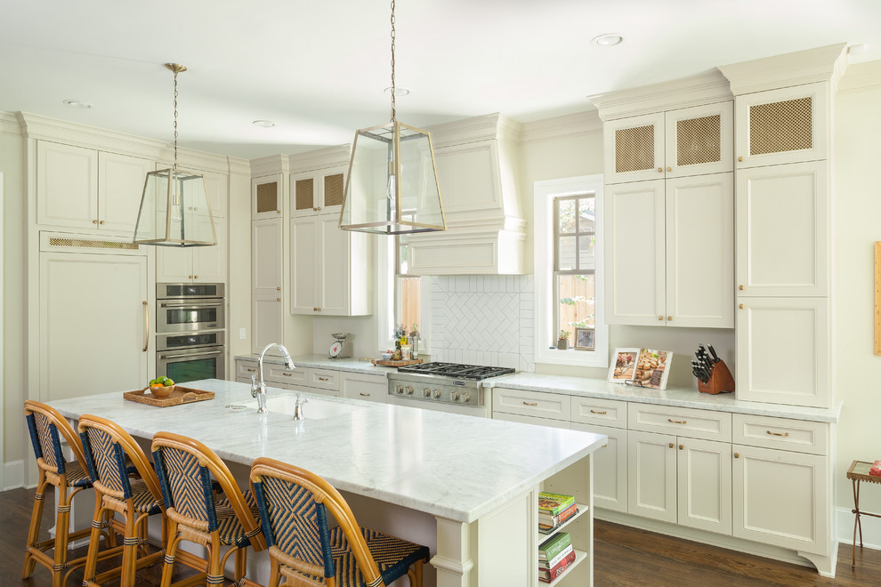 Traditional kitchen in Houston with recessed-panel cabinets, white cabinets and an island.