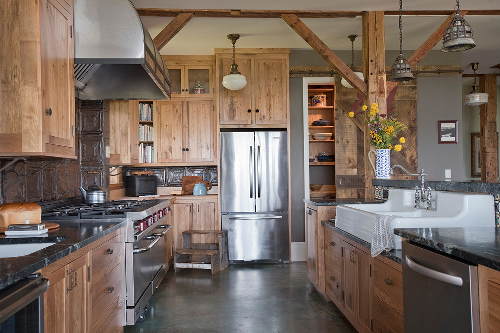 Kitchen - large farmhouse concrete floor kitchen idea in Burlington with shaker cabinets, medium tone wood cabinets, granite countertops, metallic backsplash, metal backsplash, stainless steel appliances and a double-bowl sink