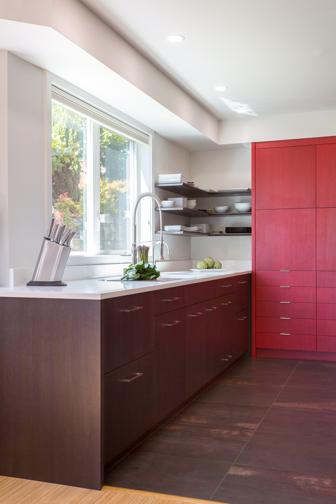 Mid-sized trendy u-shaped porcelain tile kitchen photo in Seattle with an undermount sink, flat-panel cabinets, red cabinets, quartz countertops, white backsplash, stone slab backsplash, stainless steel appliances and a peninsula