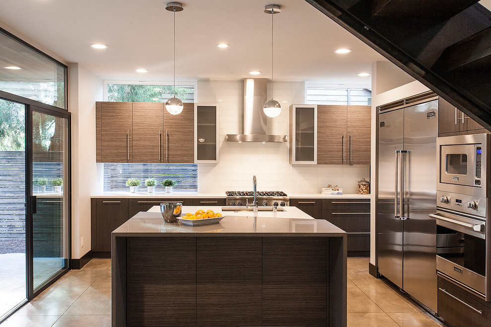 Eat-in kitchen - mid-sized contemporary u-shaped porcelain tile eat-in kitchen idea in Seattle with flat-panel cabinets, quartz countertops, white backsplash, stainless steel appliances, an island, a drop-in sink, medium tone wood cabinets and subway tile backsplash