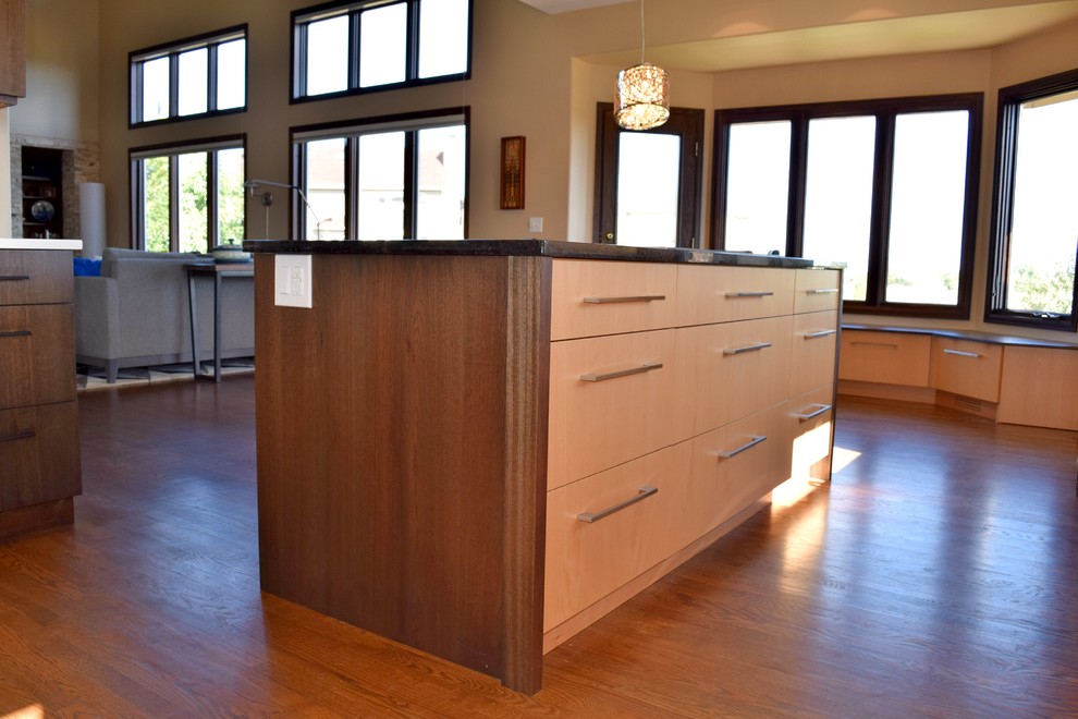 Exemple d'une cuisine ouverte tendance en bois foncé avec un placard à porte plane, un électroménager en acier inoxydable, un sol en bois brun et 2 îlots.