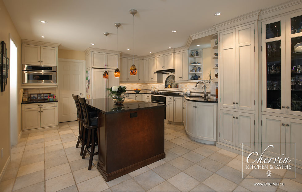 Enclosed kitchen - mid-sized transitional l-shaped enclosed kitchen idea in Toronto with an undermount sink, shaker cabinets, white cabinets, granite countertops, beige backsplash, black appliances and an island
