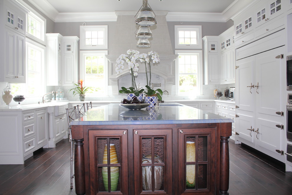 Elegant u-shaped enclosed kitchen photo in San Francisco with beaded inset cabinets, white cabinets and an island