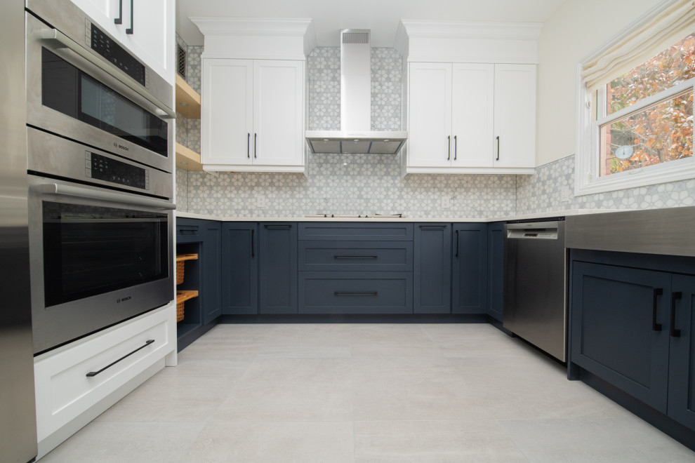 Inspiration for a transitional u-shaped porcelain tile and gray floor eat-in kitchen remodel in Toronto with a farmhouse sink, shaker cabinets, quartz countertops, multicolored backsplash, mosaic tile backsplash, stainless steel appliances, no island and multicolored countertops