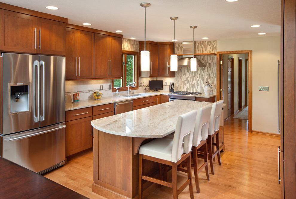 Design ideas for a contemporary kitchen in Columbus with shaker cabinets, granite worktops, stainless steel appliances and dark wood cabinets.