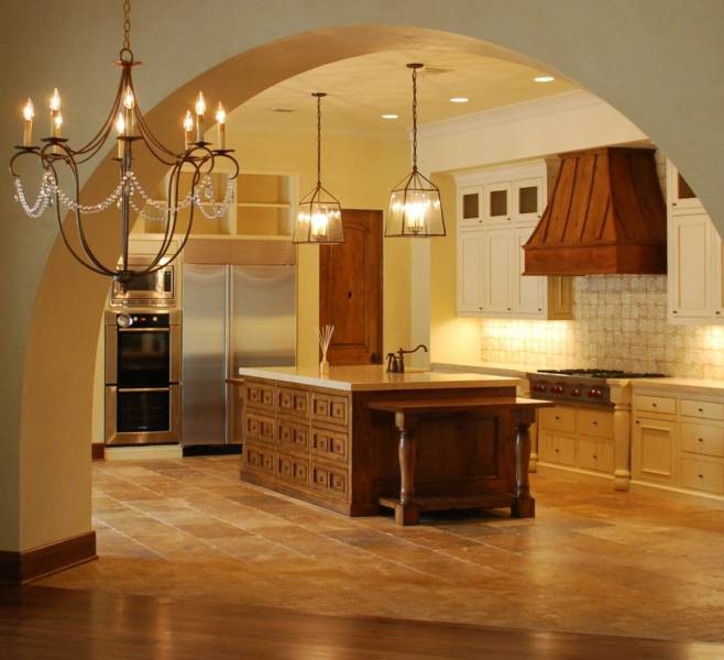 Open concept kitchen - large mediterranean l-shaped ceramic tile open concept kitchen idea in Other with white cabinets, beige backsplash, stainless steel appliances, an island, a farmhouse sink, shaker cabinets, limestone countertops and cement tile backsplash