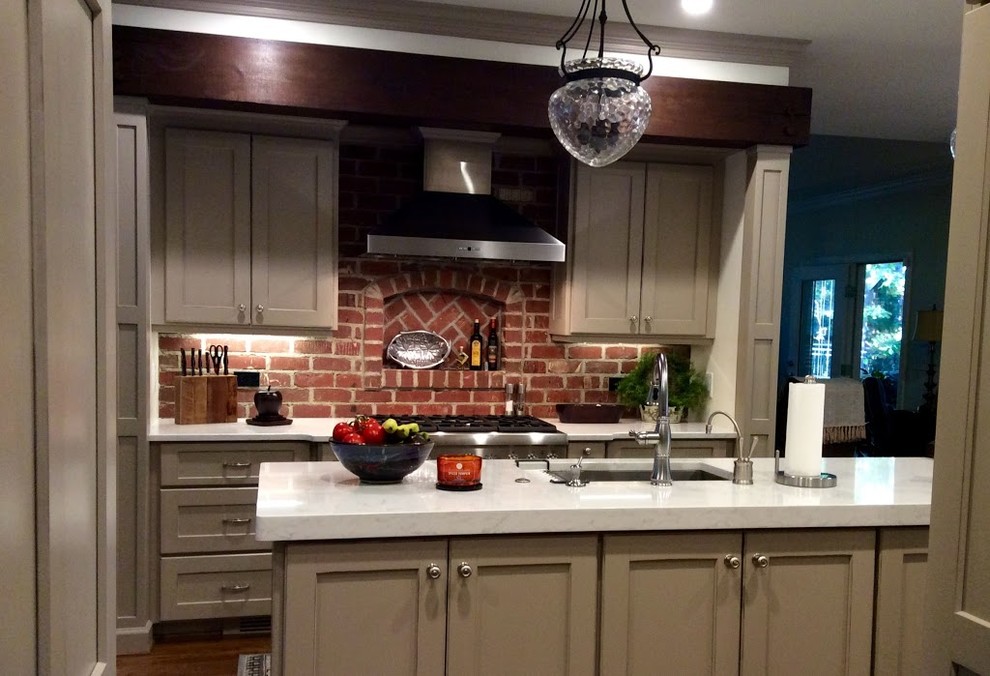Bild på ett mellanstort vintage kök, med en undermonterad diskho, skåp i shakerstil, beige skåp, bänkskiva i kvarts, rött stänkskydd, stänkskydd i tegel, rostfria vitvaror, mörkt trägolv och en köksö