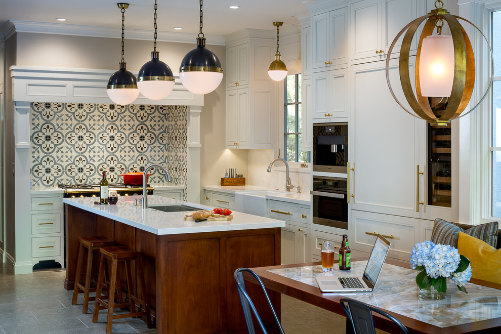 Inspiration for a timeless u-shaped gray floor eat-in kitchen remodel in San Francisco with a farmhouse sink, shaker cabinets, white cabinets, multicolored backsplash, black appliances, an island, cement tile backsplash, solid surface countertops and white countertops