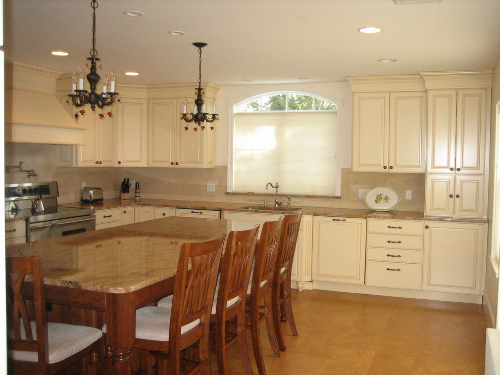 Example of a mid-sized classic l-shaped cork floor eat-in kitchen design in Providence with a single-bowl sink, raised-panel cabinets, yellow cabinets, granite countertops, beige backsplash, stone tile backsplash, paneled appliances and an island