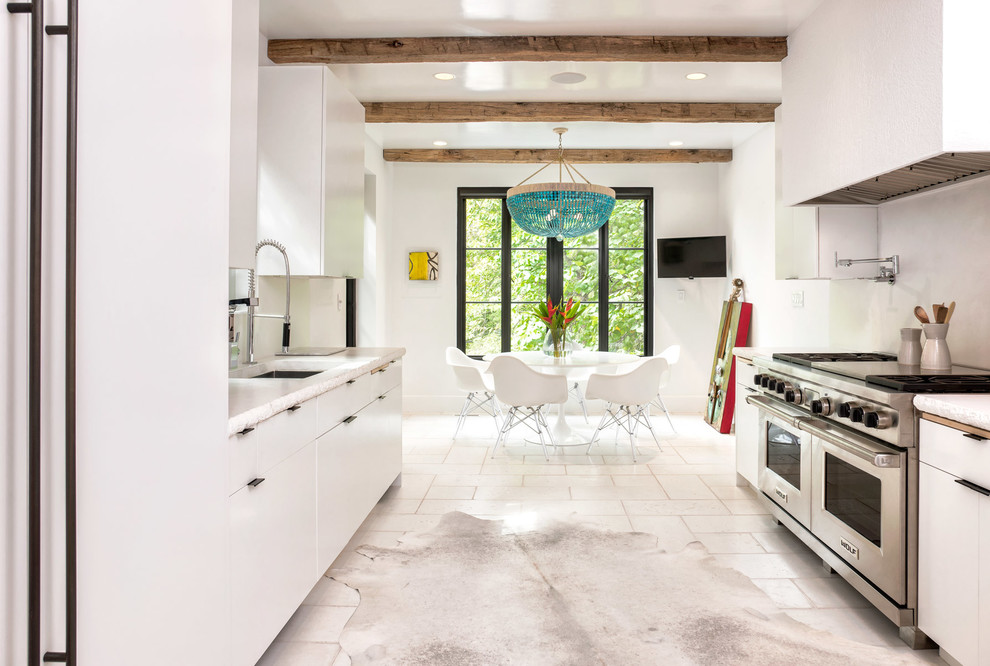 This is an example of a contemporary galley kitchen/diner in DC Metro with a submerged sink, flat-panel cabinets, white cabinets, glass sheet splashback, stainless steel appliances and no island.
