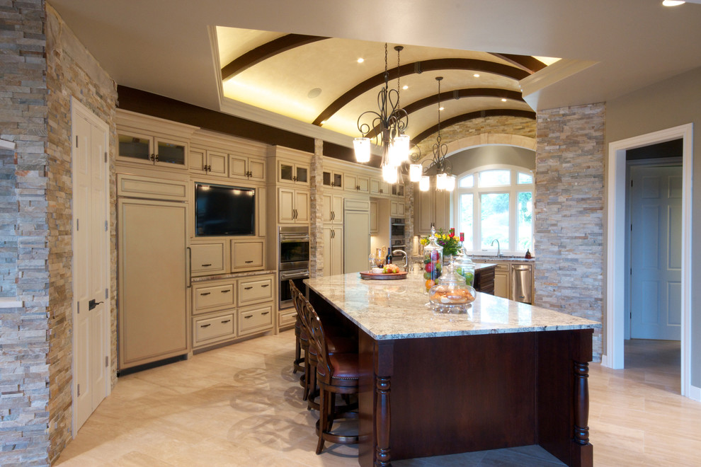 Inspiration for a large timeless u-shaped travertine floor eat-in kitchen remodel in Austin with raised-panel cabinets, beige cabinets, stainless steel appliances, an island, a single-bowl sink and granite countertops