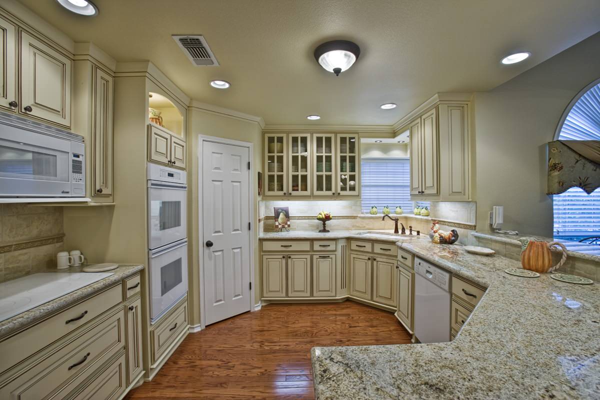 The kitchen features granite countertops, electric appliances, and