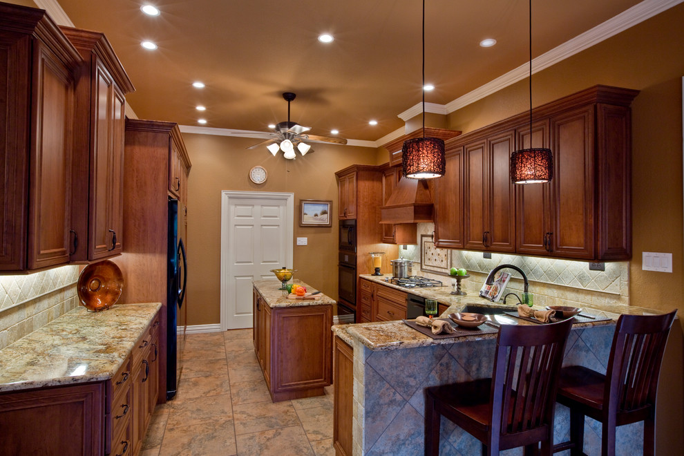 Large elegant galley porcelain tile and multicolored floor eat-in kitchen photo in Dallas with an undermount sink, recessed-panel cabinets, dark wood cabinets, granite countertops, beige backsplash, travertine backsplash, black appliances and an island
