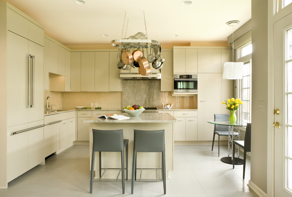 This is an example of a contemporary l-shaped kitchen/diner in DC Metro with a submerged sink, flat-panel cabinets, beige cabinets, beige splashback and integrated appliances.