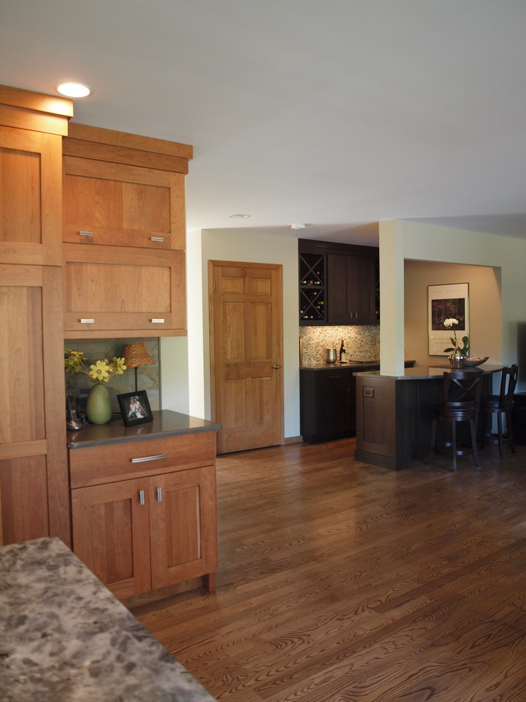 Photo of a large contemporary open plan kitchen in Chicago with shaker cabinets, light wood cabinets, medium hardwood flooring and an island.