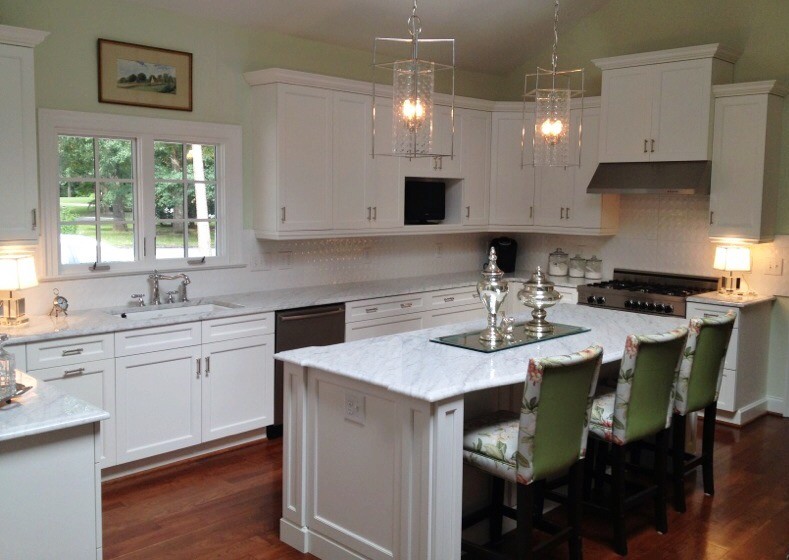 Photo of a traditional kitchen in Raleigh with shaker cabinets, white cabinets, marble worktops, white splashback, stainless steel appliances, dark hardwood flooring and an island.