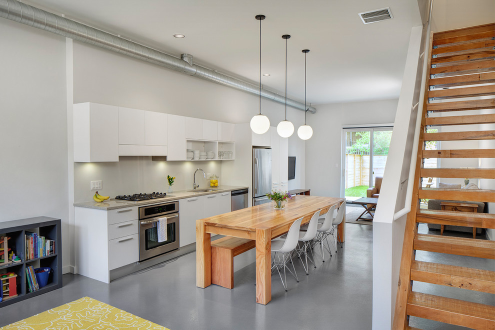 Photo of a contemporary single-wall kitchen in Chicago with flat-panel cabinets and white cabinets.