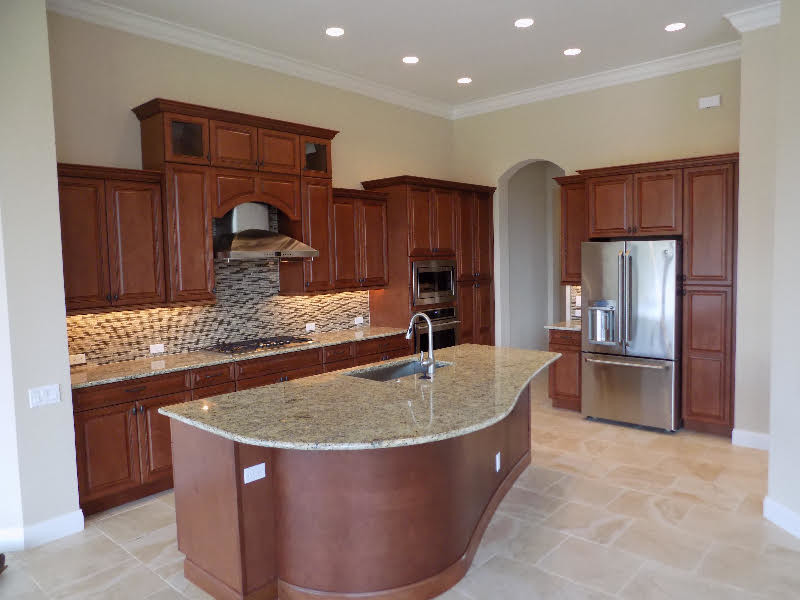 Mid-sized traditional l-shaped eat-in kitchen in Tampa with a single-bowl sink, raised-panel cabinets, dark wood cabinets, granite benchtops, beige splashback, matchstick tile splashback, stainless steel appliances, limestone floors, with island and beige floor.