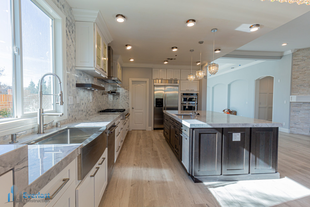 This is an example of a large modern l-shaped kitchen/diner in San Francisco with white cabinets and an island.