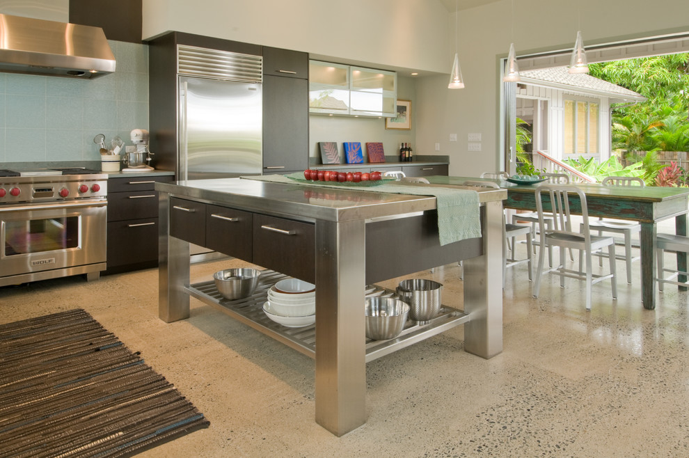 Design ideas for a large world-inspired l-shaped kitchen/diner in Hawaii with a submerged sink, flat-panel cabinets, dark wood cabinets, granite worktops, blue splashback, ceramic splashback, stainless steel appliances and an island.