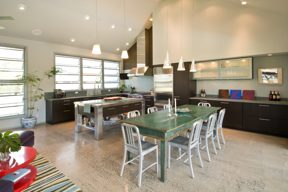 Example of a large island style l-shaped eat-in kitchen design in Hawaii with an undermount sink, blue backsplash, ceramic backsplash, stainless steel appliances, flat-panel cabinets, dark wood cabinets, granite countertops and an island