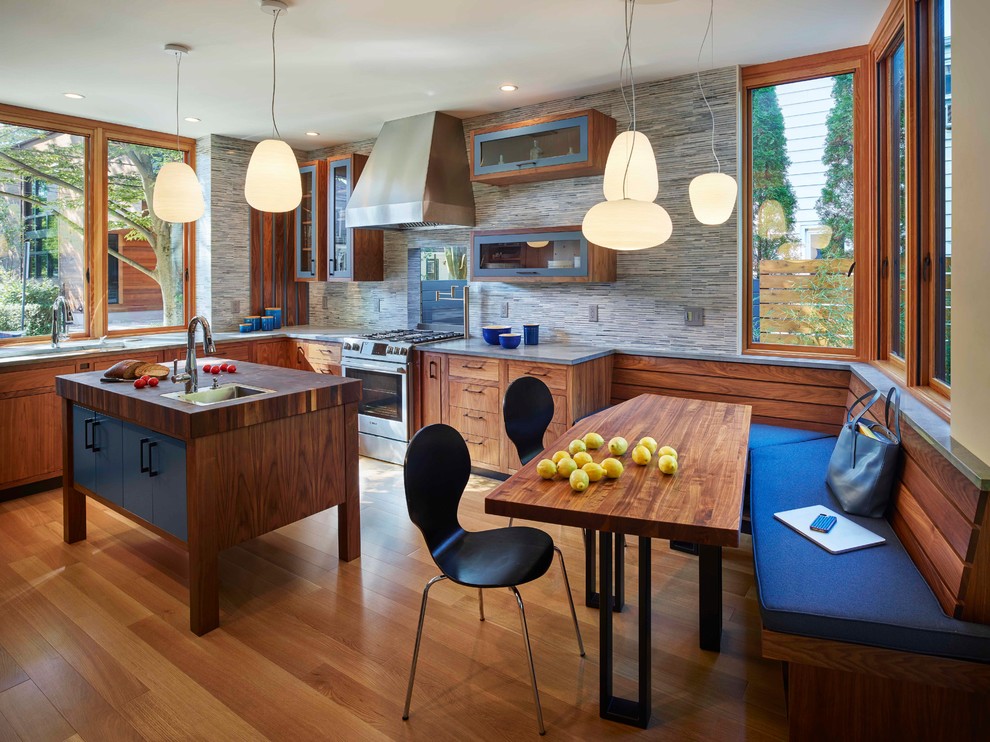 Mid-sized trendy light wood floor eat-in kitchen photo in Philadelphia with an undermount sink, open cabinets, medium tone wood cabinets, wood countertops, gray backsplash, stone tile backsplash, stainless steel appliances and an island