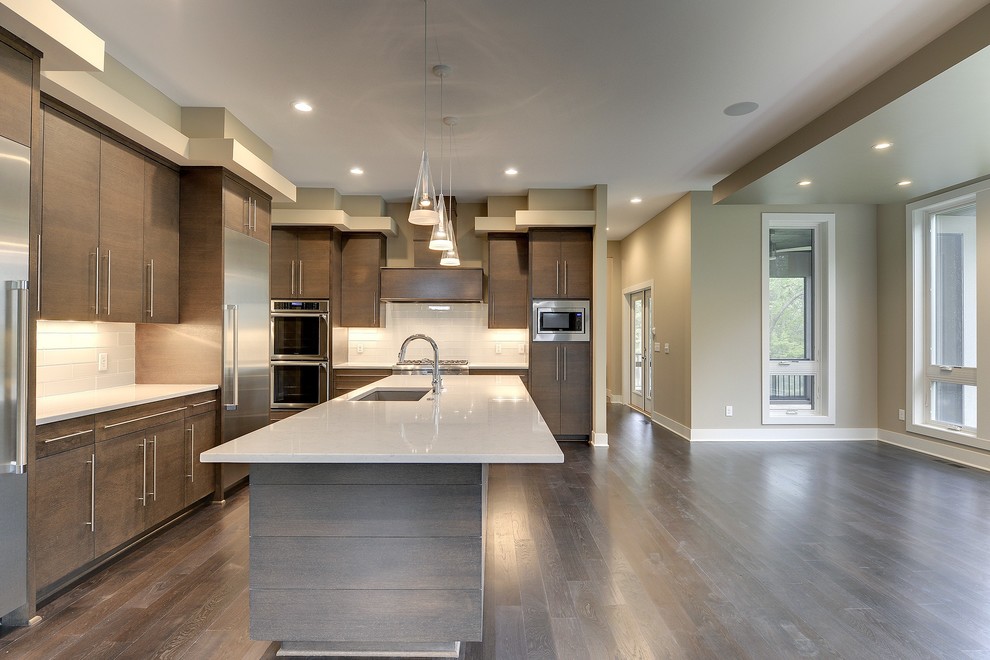 Example of a large transitional single-wall dark wood floor eat-in kitchen design in Minneapolis with an undermount sink, flat-panel cabinets, dark wood cabinets, marble countertops, white backsplash, porcelain backsplash, stainless steel appliances and an island