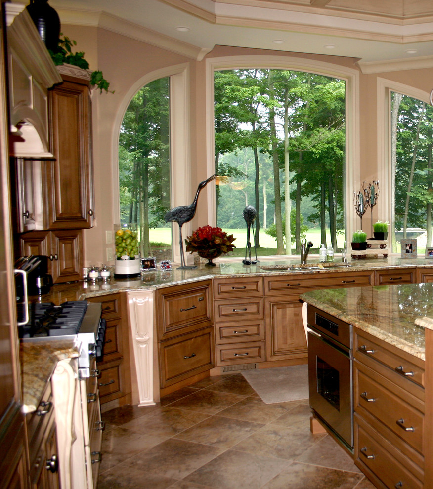 Traditional u-shaped kitchen/diner in Other with a submerged sink, raised-panel cabinets, medium wood cabinets, granite worktops and stainless steel appliances.