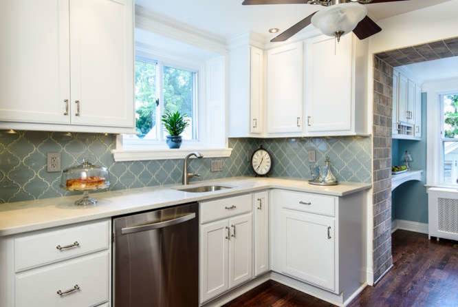 Example of a classic medium tone wood floor kitchen pantry design in Philadelphia with an undermount sink, shaker cabinets, white cabinets, quartz countertops, blue backsplash, glass tile backsplash and stainless steel appliances
