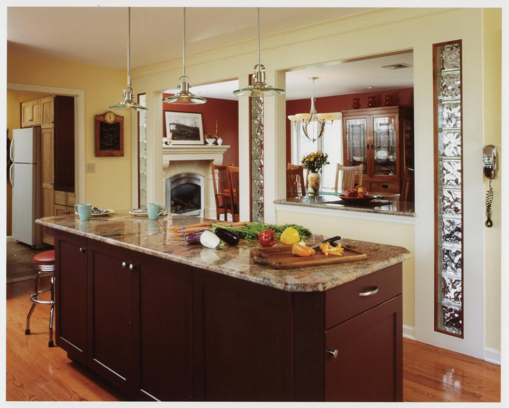 Contemporary u-shaped kitchen/diner in Bridgeport with flat-panel cabinets, dark wood cabinets and granite worktops.