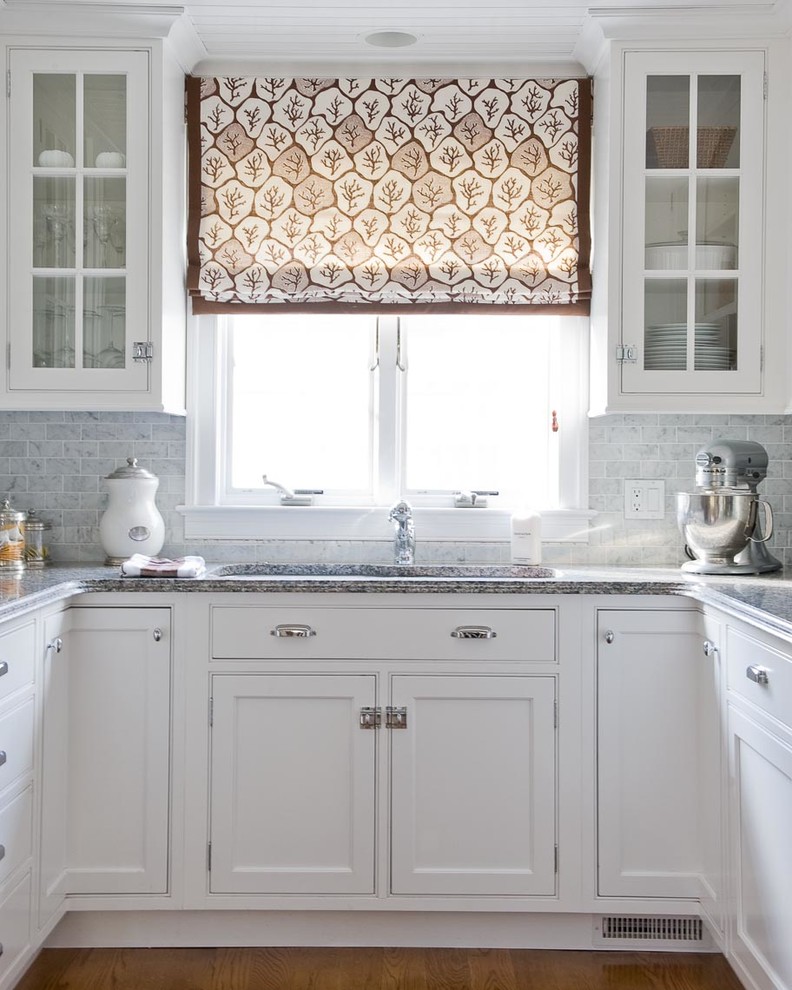 Classic kitchen in New York with beaded cabinets, white cabinets, white splashback and stone tiled splashback.