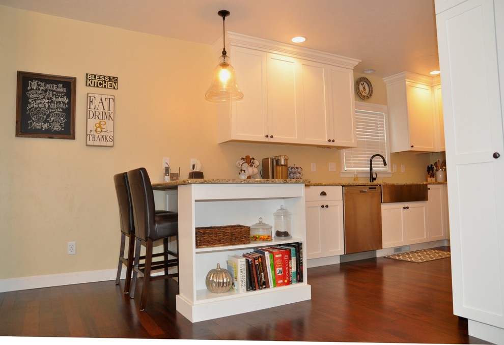 Example of a small minimalist u-shaped dark wood floor and brown floor eat-in kitchen design in Other with a farmhouse sink, white cabinets, granite countertops, stainless steel appliances, a peninsula and shaker cabinets