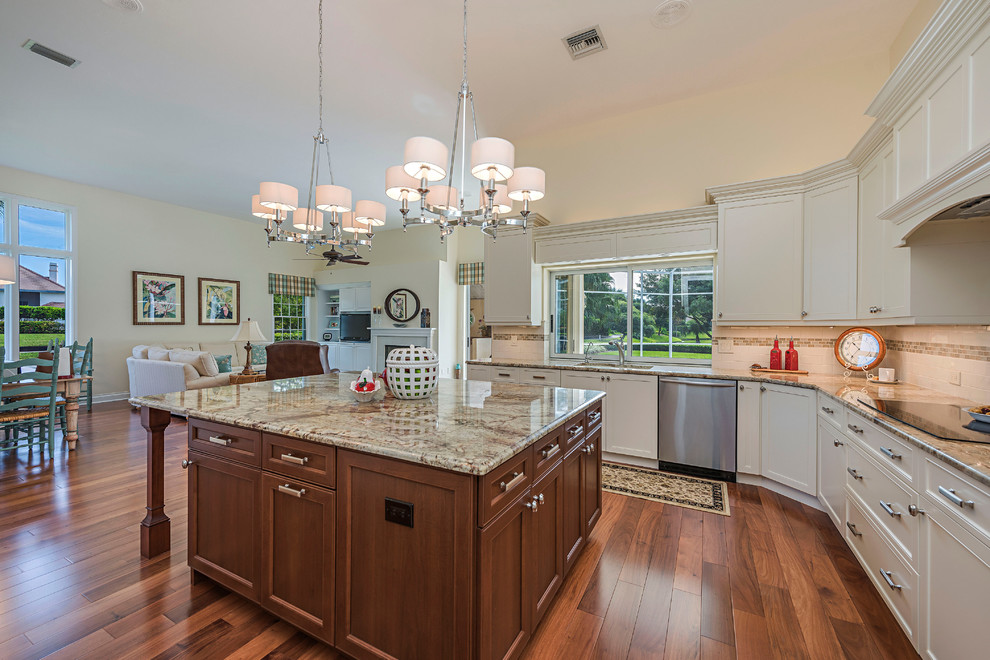 Inspiration for a large contemporary u-shaped medium tone wood floor and brown floor eat-in kitchen remodel in Miami with a double-bowl sink, recessed-panel cabinets, white cabinets, marble countertops, white backsplash, subway tile backsplash, stainless steel appliances and an island