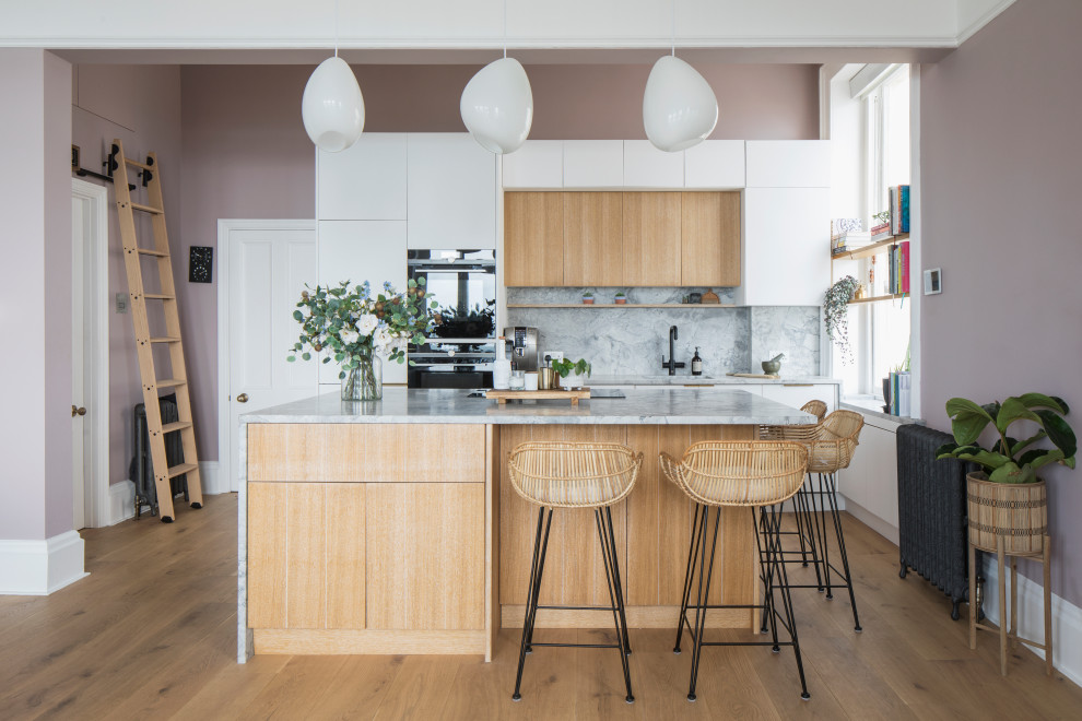 Inspiration for a medium sized scandi single-wall open plan kitchen in Sussex with a submerged sink, flat-panel cabinets, light wood cabinets, marble worktops, grey splashback, marble splashback, integrated appliances, light hardwood flooring, an island, brown floors, grey worktops and a coffered ceiling.