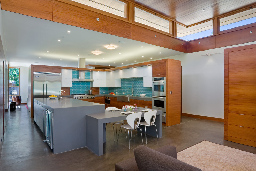 Свежая идея для дизайна: угловая кухня-гостиная в современном стиле с с полувстраиваемой мойкой (с передним бортиком) и фартуком из плитки кабанчик - отличное фото интерьера