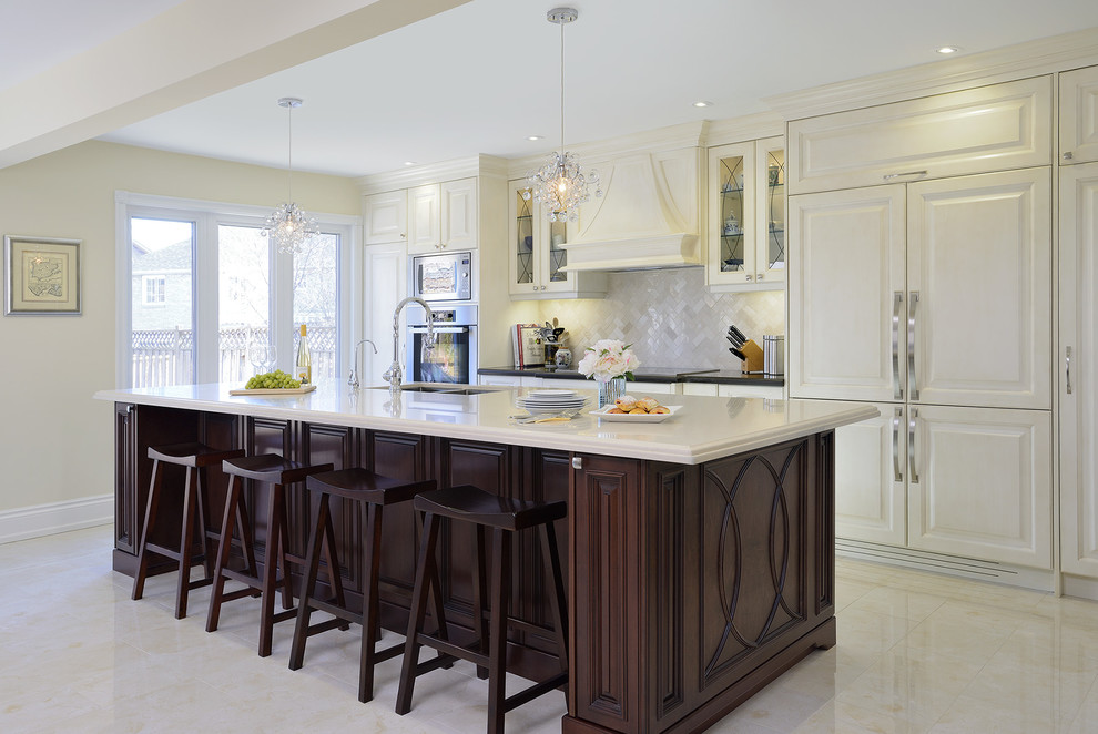 Inspiration for a mid-sized timeless galley porcelain tile kitchen remodel in Toronto with an undermount sink, raised-panel cabinets, quartz countertops, beige backsplash, paneled appliances, an island and white cabinets