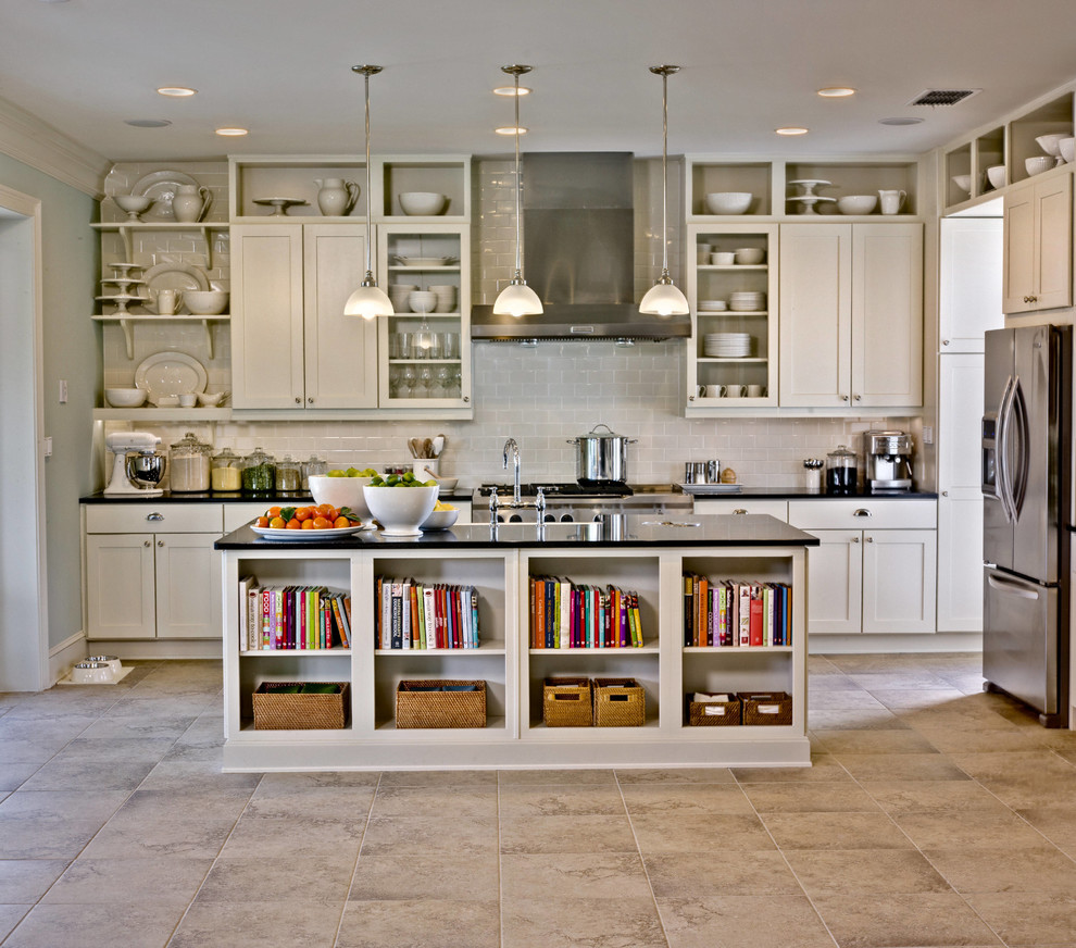 Elegant galley kitchen photo in San Francisco with shaker cabinets, beige cabinets, beige backsplash, subway tile backsplash and stainless steel appliances