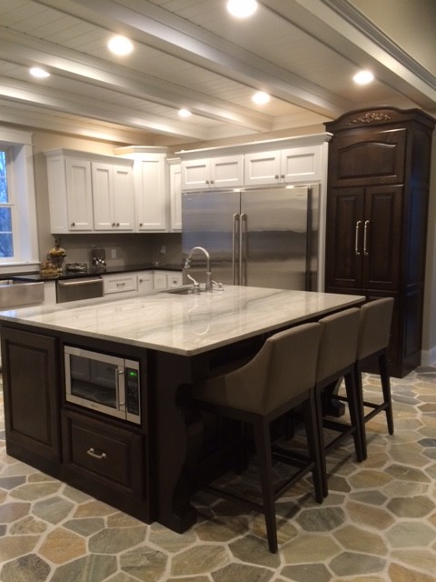Inspiration for a large contemporary l-shaped kitchen/diner in Minneapolis with a built-in sink, shaker cabinets, white cabinets, marble worktops, grey splashback, stainless steel appliances and an island.