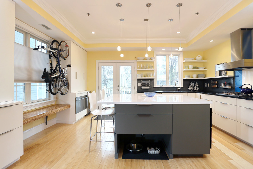 ボストンにある高級な中くらいなコンテンポラリースタイルのおしゃれなキッチン (フラットパネル扉のキャビネット、白いキャビネット、グレーのキッチンパネル、淡色無垢フローリング、ベージュの床、ソープストーンカウンター) の写真