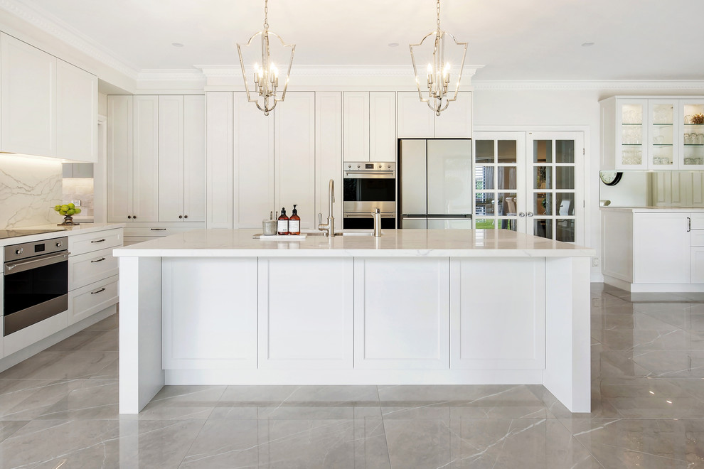 Example of a large classic l-shaped porcelain tile and brown floor open concept kitchen design in Sydney with an undermount sink, shaker cabinets, beige cabinets, quartz countertops, gray backsplash, stone slab backsplash, stainless steel appliances, an island and white countertops
