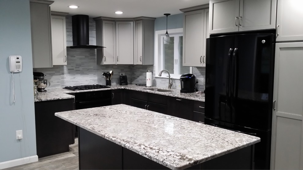 This is an example of a medium sized classic u-shaped open plan kitchen in Boston with a submerged sink, shaker cabinets, black cabinets, granite worktops, grey splashback, glass tiled splashback, stainless steel appliances, slate flooring, an island and grey floors.